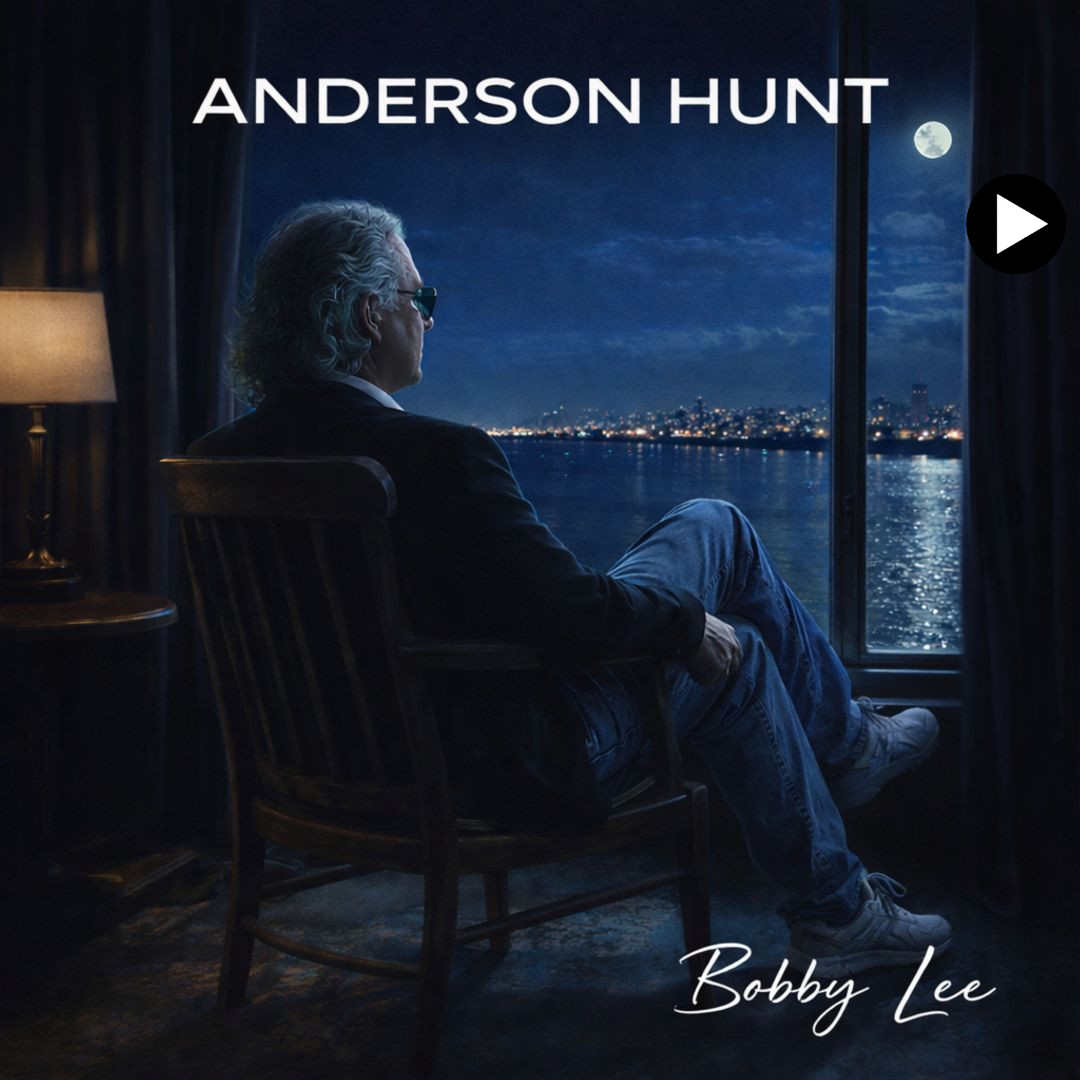 Album cover for "Bobby Lee" by Anderson Hunt, showing a man with sunglasses sitting in a wooden chair inside a dark room, looking out a large window at a city skyline across a body of water at night under a full moon.